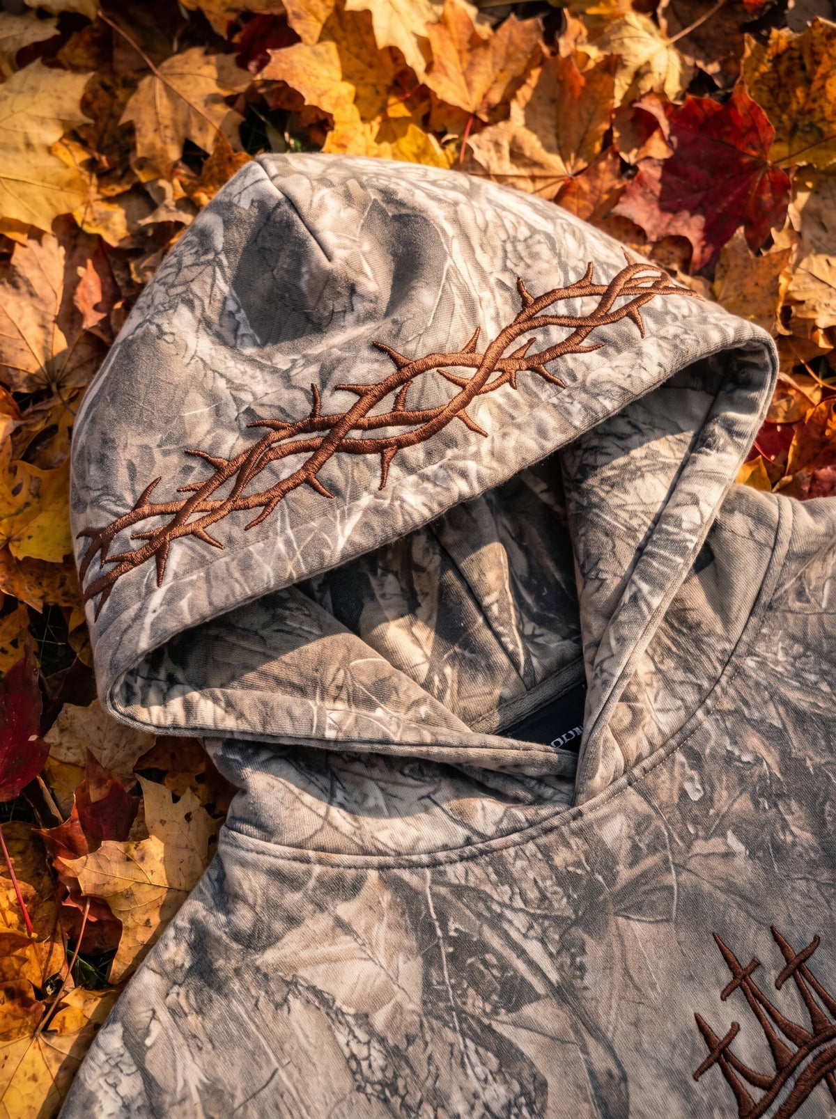 Crown of thorns embroidery on the hoodie's hood